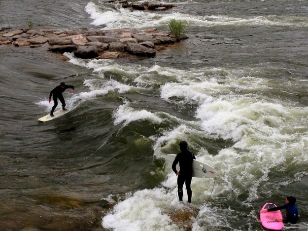 Brave souls surf on the Clark Fork River that runs through town